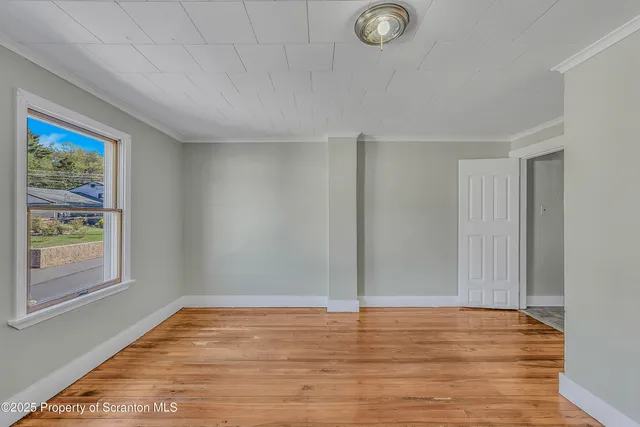 a view of room with window and wooden floor