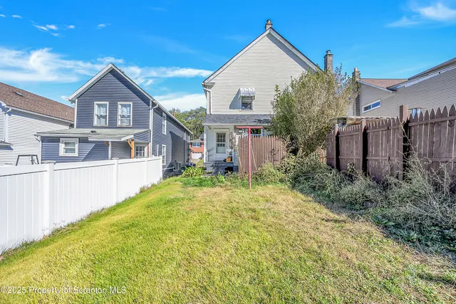 a view of a house with a small yard and plants