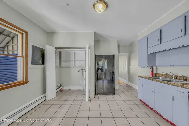 a kitchen with sink cabinets and refrigerator