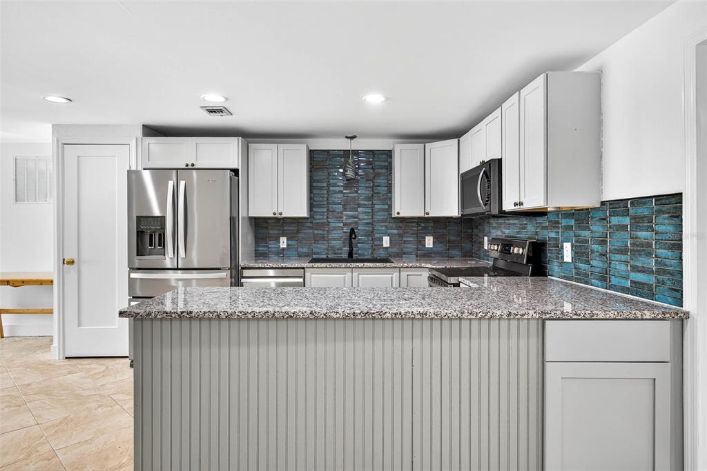3225 West Shell Point Road Ruskin, FL 33570 - Photo 21 of 67 a kitchen with stainless steel appliances granite countertop a sink and a granite counter tops