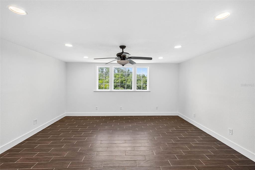 3225 West Shell Point Road Ruskin, FL 33570 - Photo 23 of 67 an empty room with wooden floor and windows