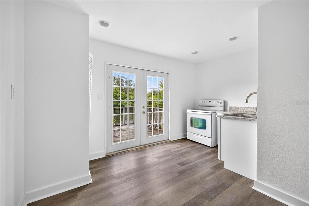 3225 West Shell Point Road Ruskin, FL 33570 - Photo 52 of 67 a kitchen with a refrigerator and a stove top oven