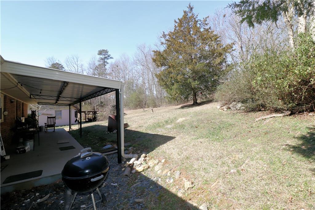 70 North Bellview Road Aragon, GA 30104 - Photo 20 of 30 a patio with table and chairs and potted plants