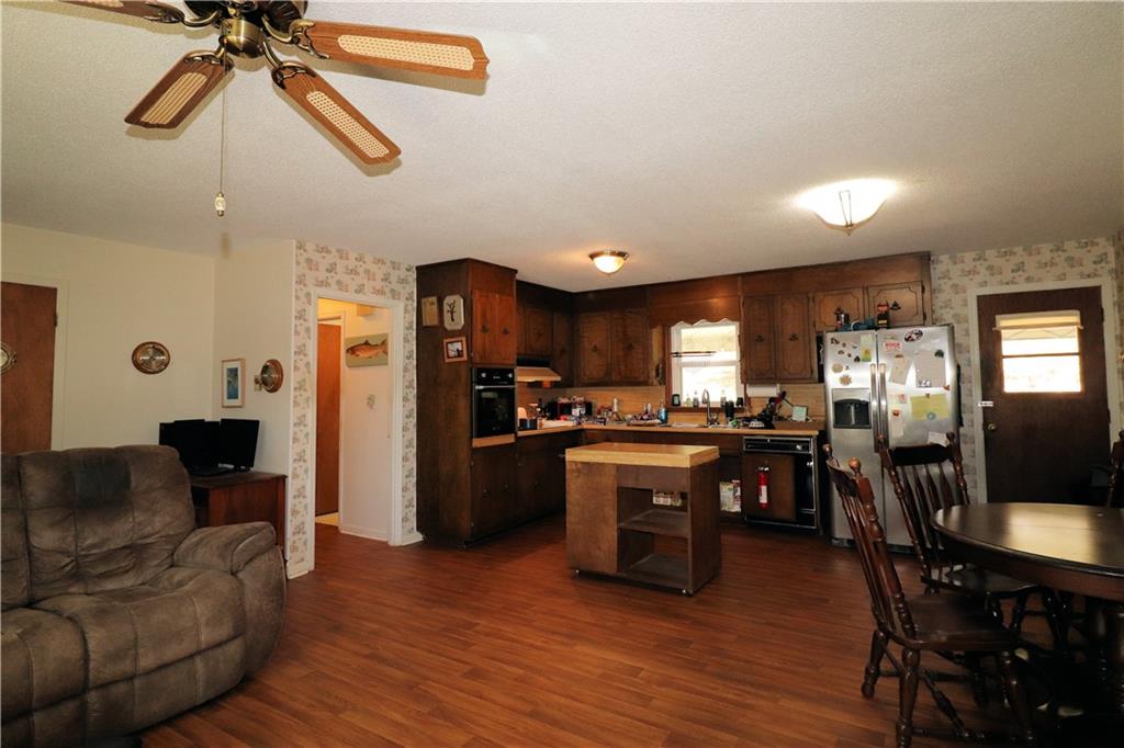 70 North Bellview Road Aragon, GA 30104 - Photo 4 of 30 a kitchen with stainless steel appliances granite countertop a refrigerator a stove a sink a dining table and chairs with wooden floor