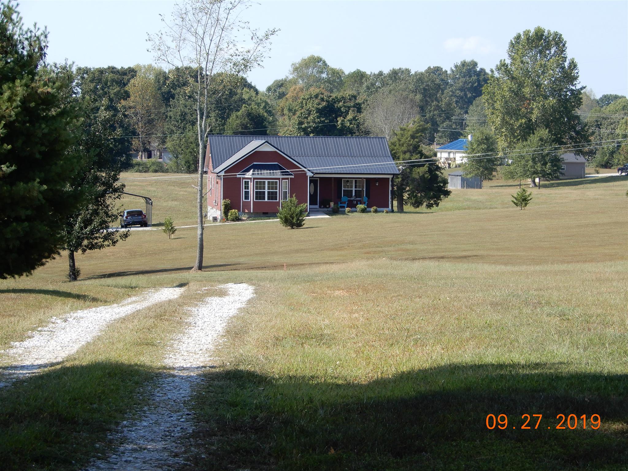 610 Murrell Road Dickson, TN 37055 - Photo 24 of 24 a view of a house with a yard next to a road