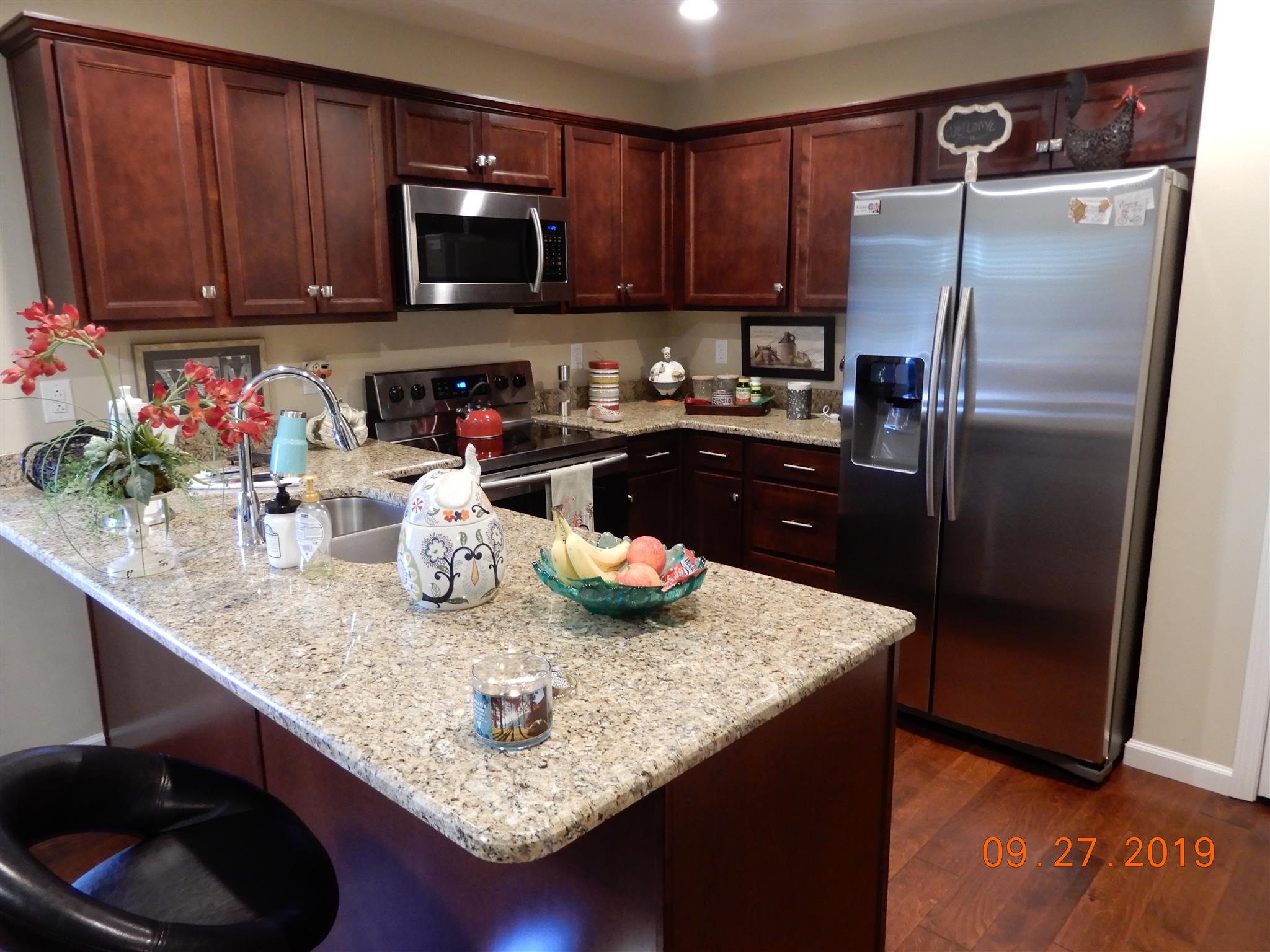 610 Murrell Road Dickson, TN 37055 - Photo 4 of 24 a kitchen with granite countertop stainless steel appliances and wooden cabinets