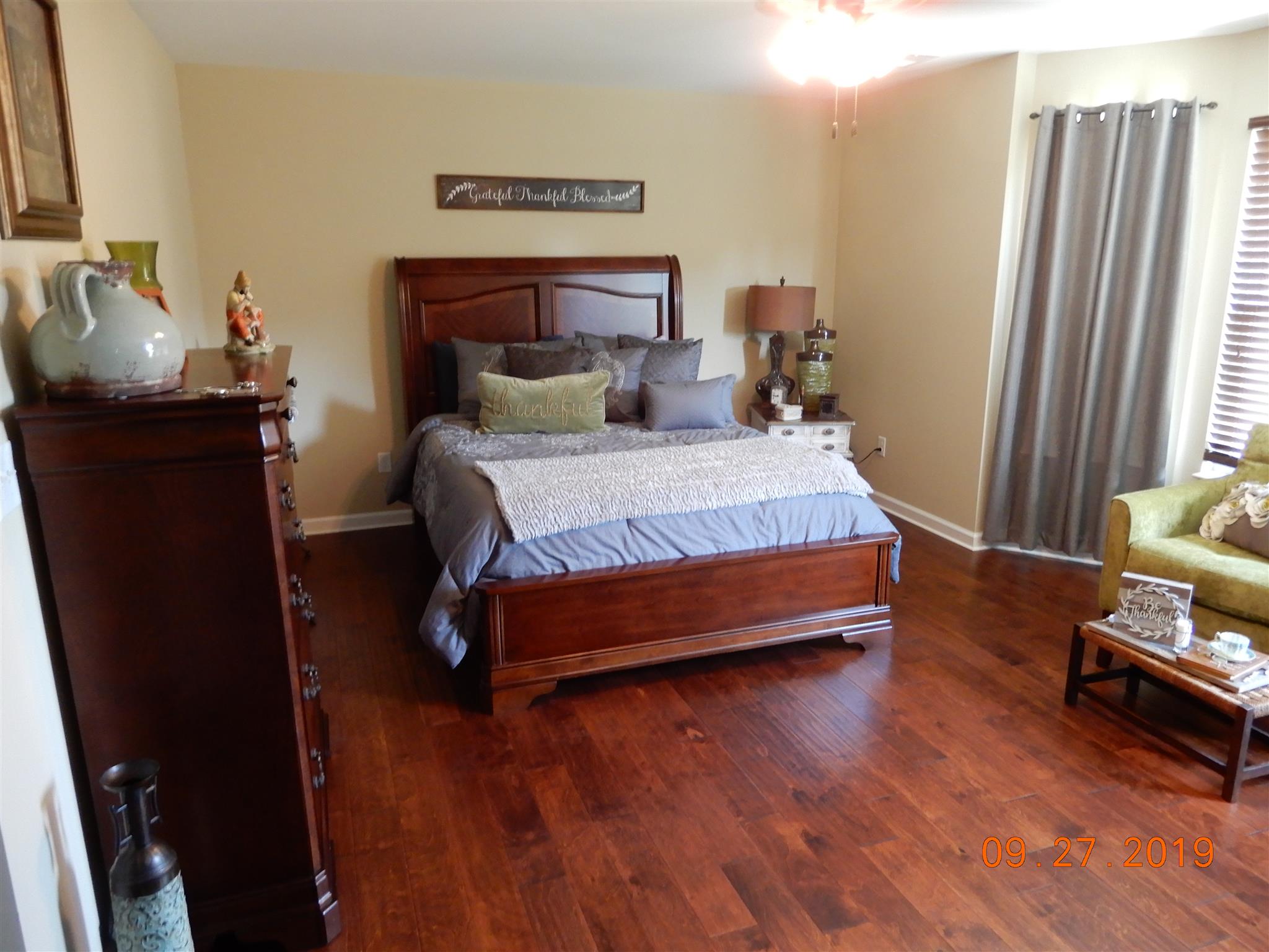 610 Murrell Road Dickson, TN 37055 - Photo 6 of 24 a bedroom with a bed and wooden floor