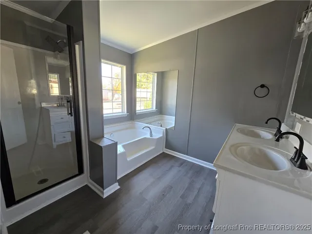 a bathroom with a tub sink and shower
