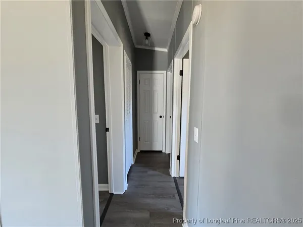 a view of hallway with wooden floor