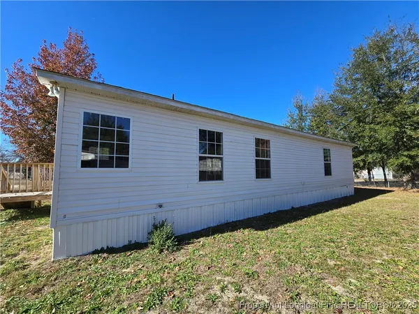 a view of a backyard with wooden fence