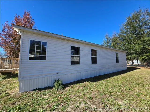 a view of a backyard with wooden fence