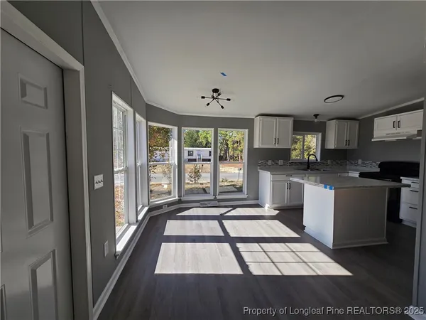 a kitchen with granite countertop a stove a sink and a refrigerator