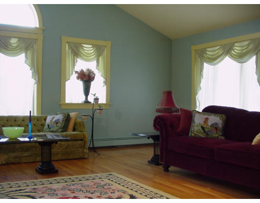 357 Central Street Georgetown, MA 01833 - Photo 6 of 21 a living room with furniture and a painting on the wall