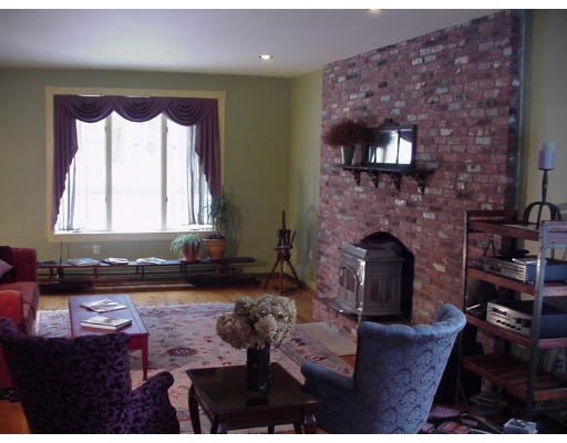 357 Central Street Georgetown, MA 01833 - Photo 9 of 21 a living room with furniture a fireplace and a flat screen tv