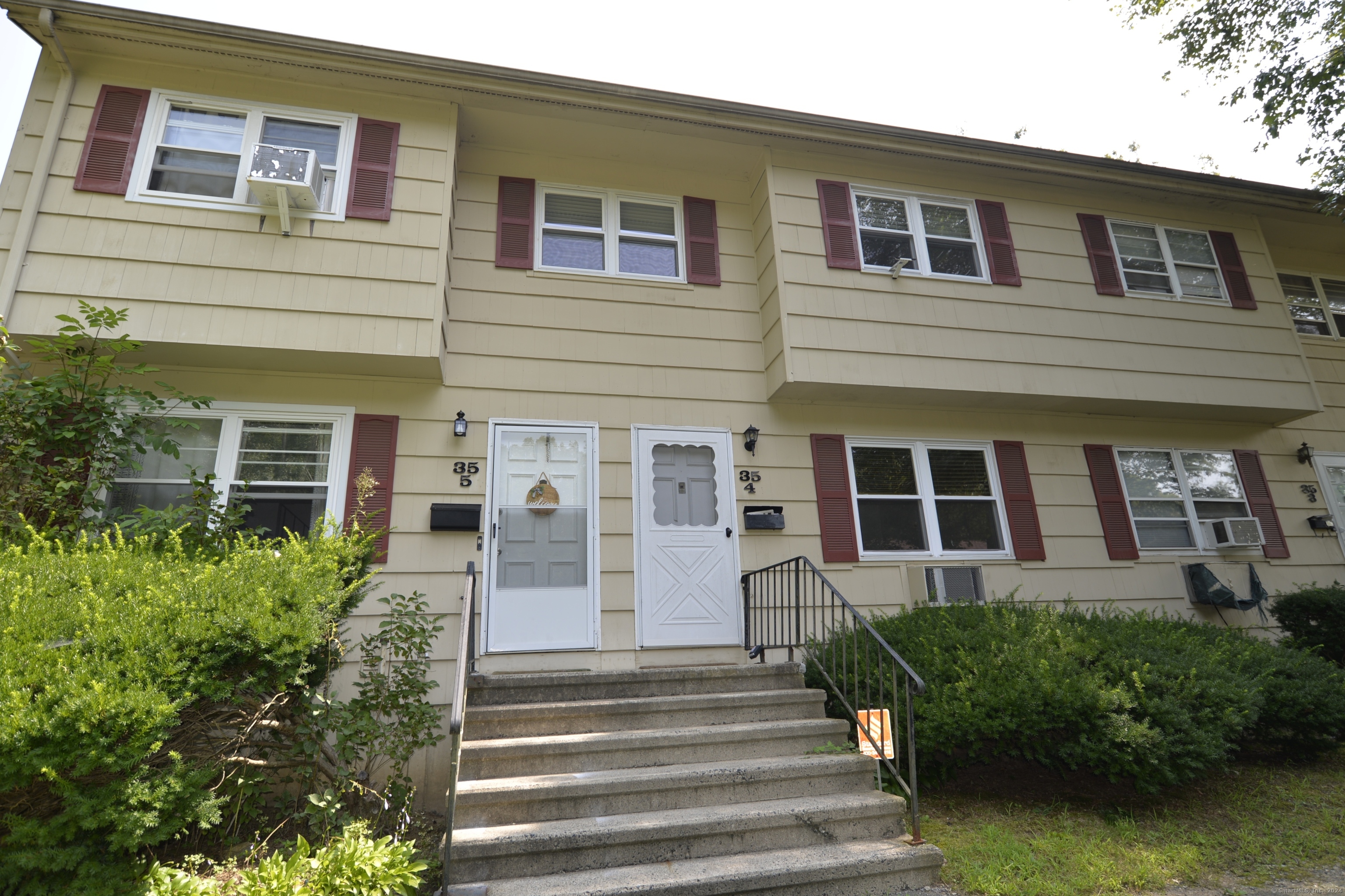 35 Coach Circle, Unit 4 Naugatuck, CT 06770 - Photo 1 of 1 a front view of a house with a yard