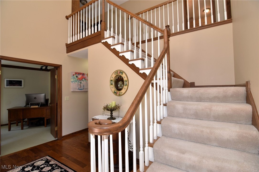 5510 Som Center Road Solon, OH 44139 - Photo 3 of 38 Staircase featuring wood finished floors, baseboards, and a towering ceiling