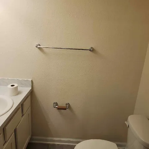 a bathroom with a toilet sink and shower