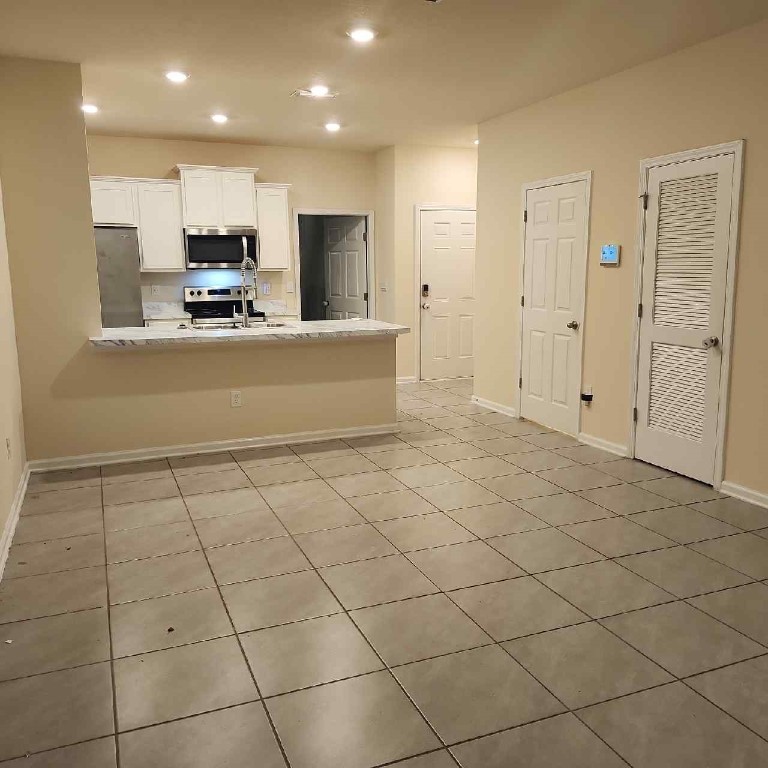 86624 Shortline Circle Yulee, FL 32097 - Photo 4 of 31 a view of kitchen with stainless steel appliances cabinets and living room view