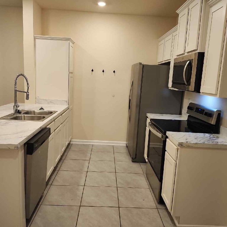86624 Shortline Circle Yulee, FL 32097 - Photo 6 of 31 a kitchen with a sink a stove and refrigerator