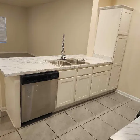 a utility room with a sink washer and dryer