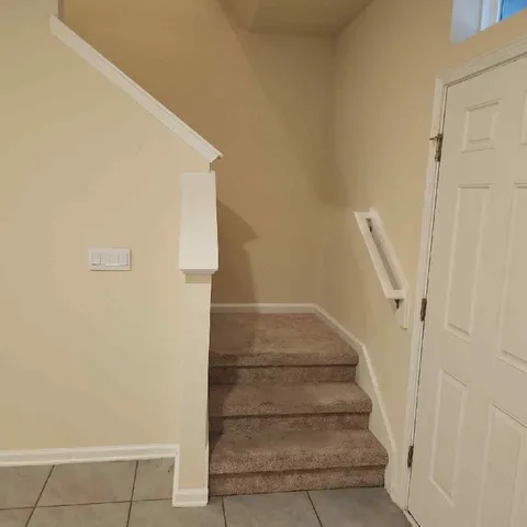 a view of staircase with white walls