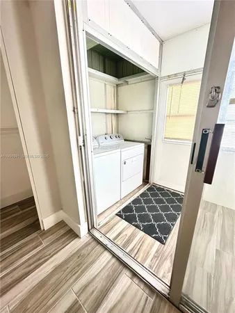 a kitchen with white cabinets and appliances