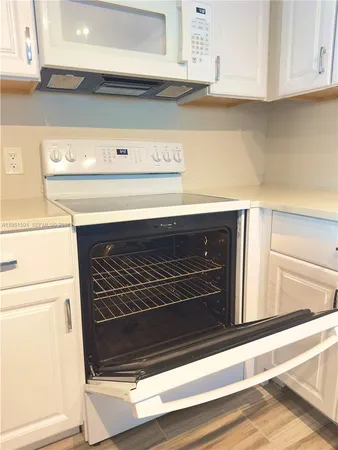 a stove top oven sitting inside of a kitchen