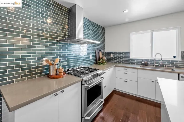 a kitchen with stainless steel appliances kitchen island a refrigerator sink and cabinets