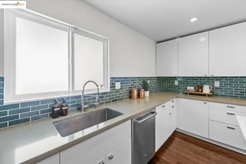 a kitchen that has a sink and a stove in it