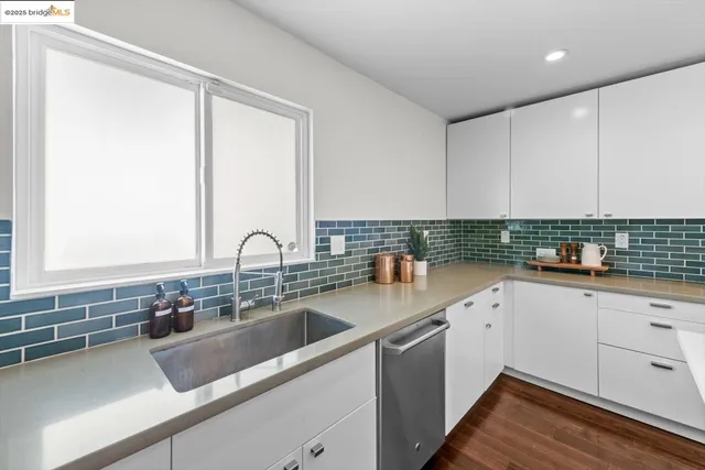 a kitchen that has a sink and a stove in it