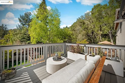 a dining room with stainless steel appliances kitchen island granite countertop a dining table chairs and wooden floor