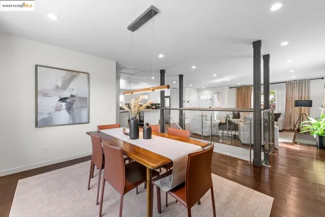 a living room with furniture and a large window with wooden floor