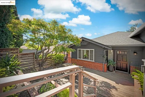 a living room with furniture a fireplace and a window