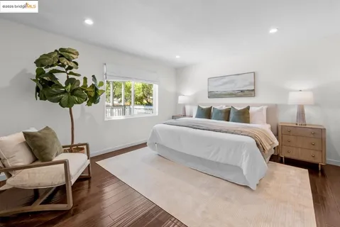 a view of a room with wooden floor and white walls