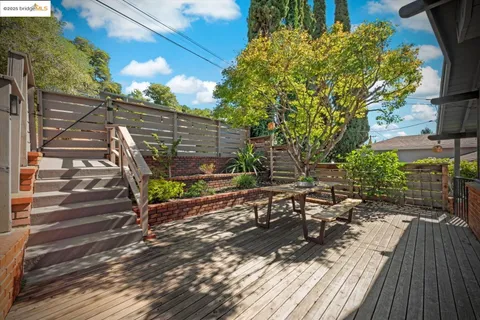 a living room with furniture and a view of kitchen