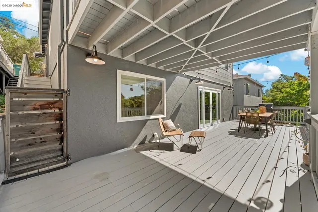 an aerial view of a house with a yard and trees all around