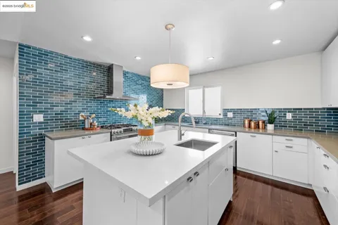 a kitchen with a stove cabinetry a sink and appliances