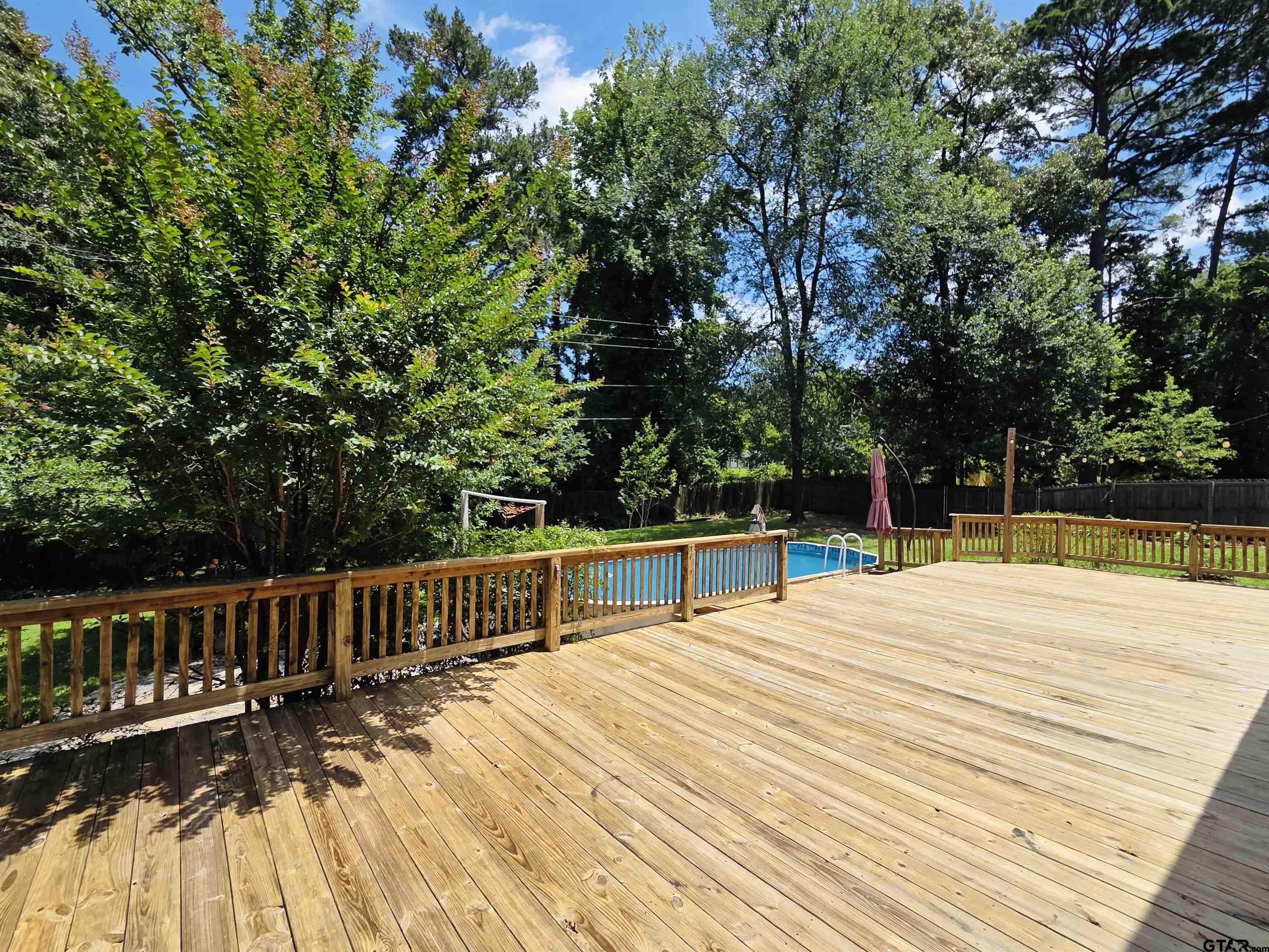 1821 Azalea Street Gilmer, TX 75644 - Photo 29 of 34 a view of balcony with deck and trees