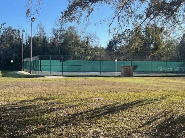 a view of a field with trees around