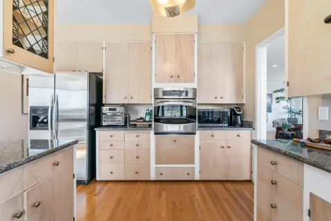 a kitchen with stainless steel appliances a refrigerator sink and cabinets