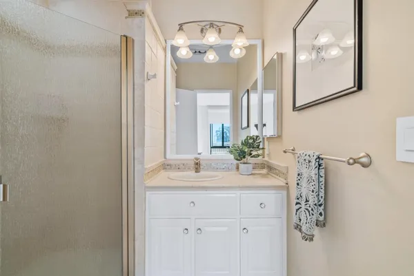a bathroom with a sink vanity and a mirror