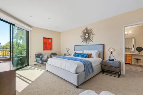 a bedroom with a bed and a chandelier