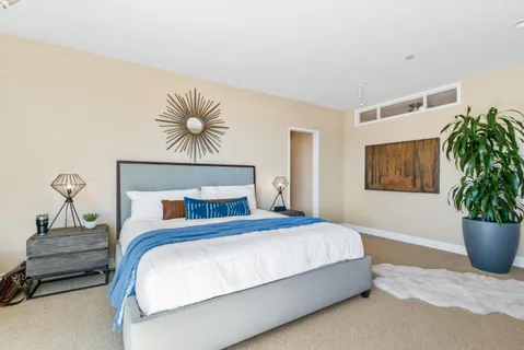 a bedroom with a bed and ceiling fan