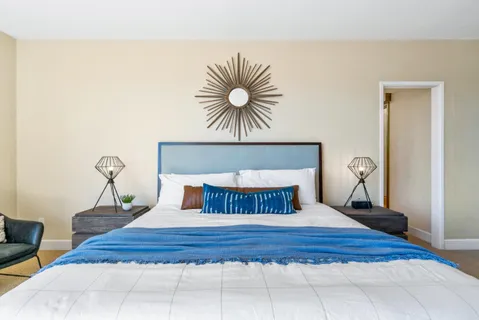 a bedroom with a bed and a mirror