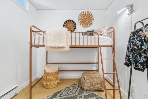 a bedroom with a bed and a window