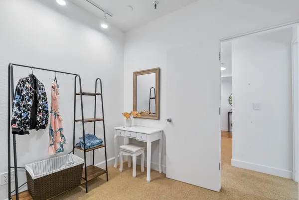 a room with furniture and a painting on the wall