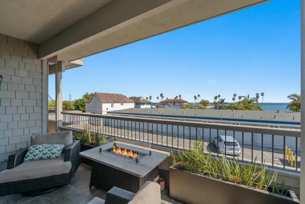 a view of a balcony with couches and wooden floor