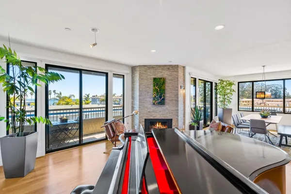 a very nice looking living room with a large window and a dining table