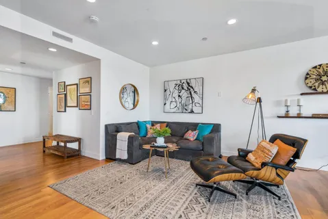 a living room with furniture and wooden floor