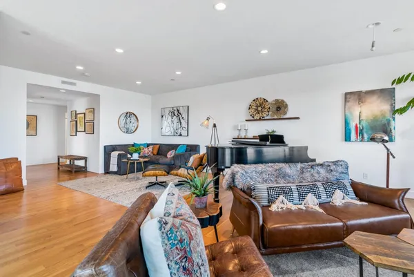 a living room with furniture and a wooden floor